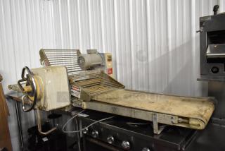 Rondo Seewer 50339 metal commercial reversible dough sheeter, bench style, 208/240 volts, used condition, safety labels visible.
