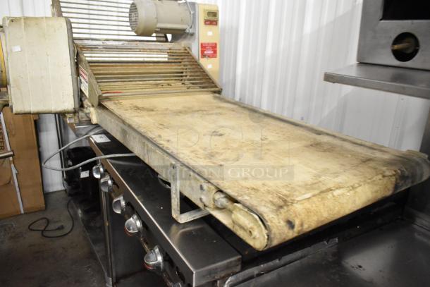 Rondo Seewer 50339 metal commercial reversible dough sheeter, bench style, used, 208/240 Volts, visible wear on surface.