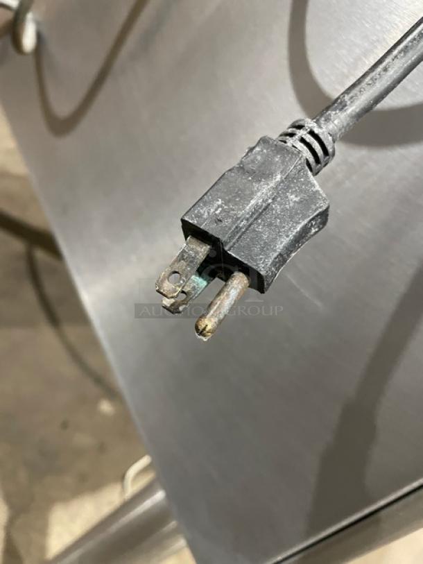 Cleveland Range electric braising pan plug and outlet detail on stainless steel surface; commercial kitchen equipment.