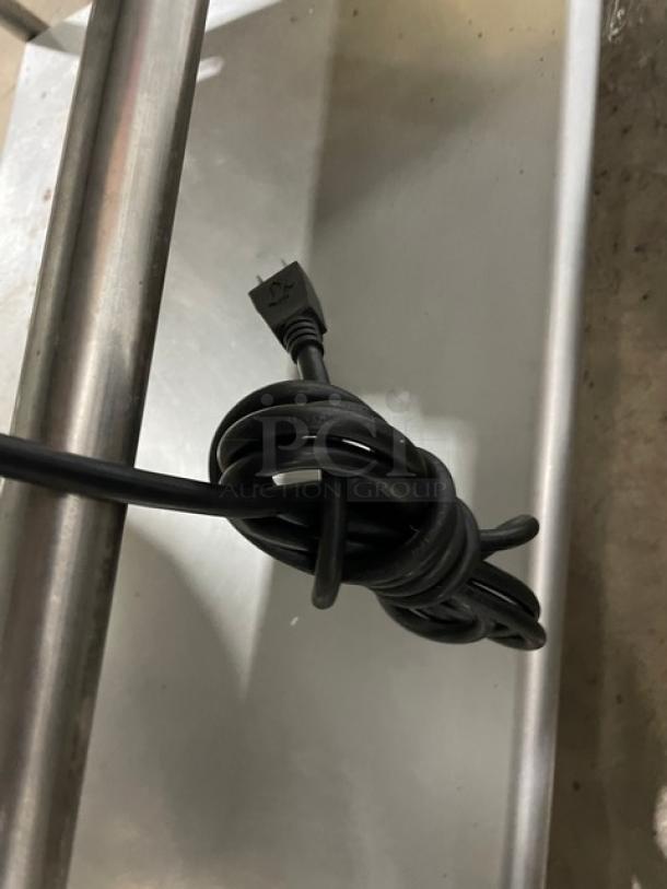 WoodStone stainless steel countertop plancha griddle cord on an undershelf equipment cart, featuring back and side splash.
