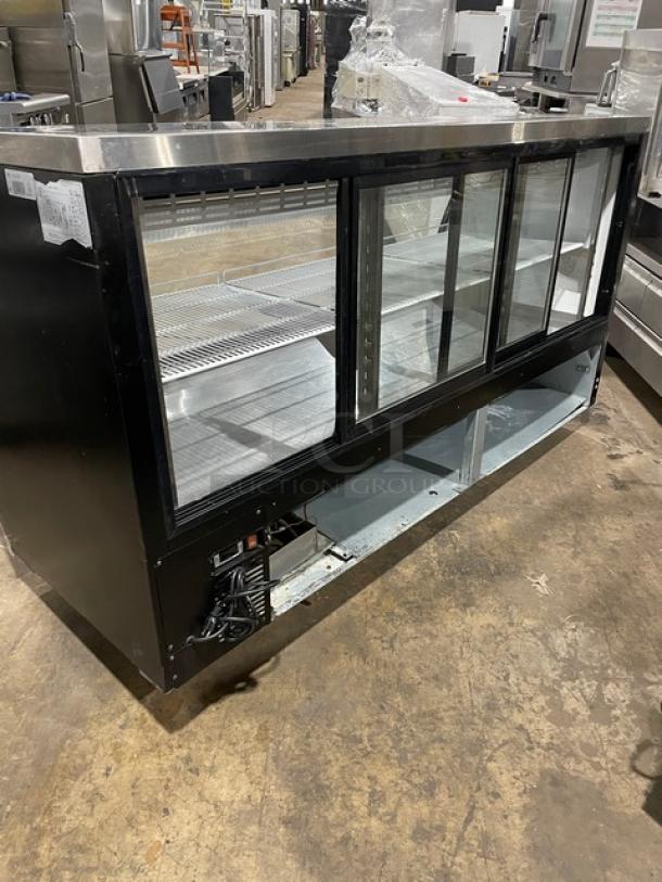 Alamo XDC200 refrigerated meat deli display with curved glass, poly-coated wire rack, rear sliding glass door, 110V.