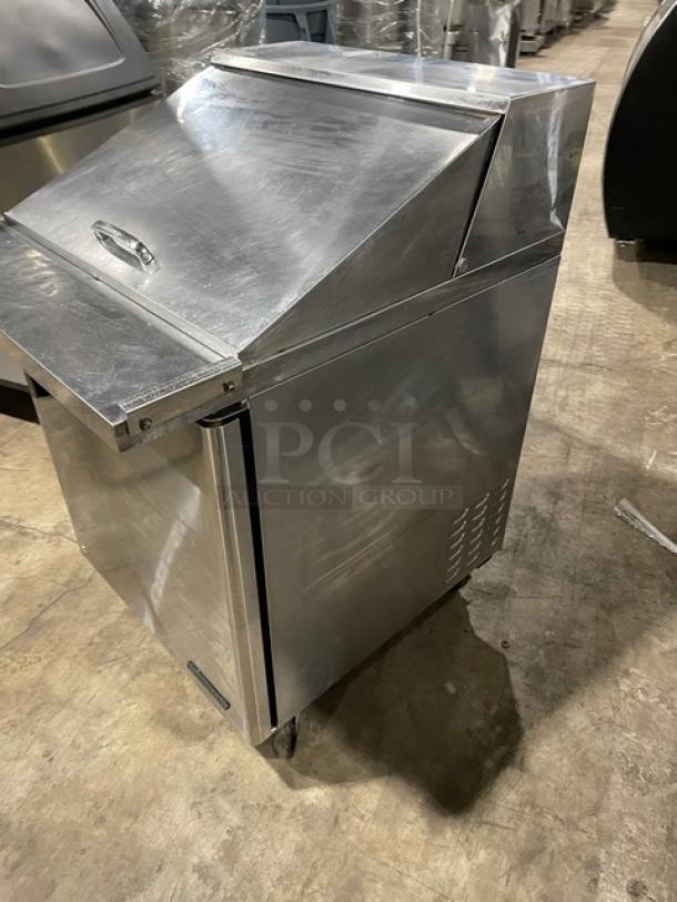 Turbo Air TST-28SD-12 stainless steel refrigerated prep table, single solid door, bain-marie style, on casters, with chrome rack.
