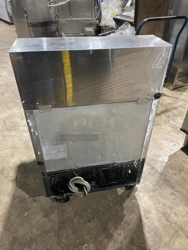Turbo Air TST-28SD-12 commercial stainless steel prep table with casters, rear view, includes power cord and chrome rack.