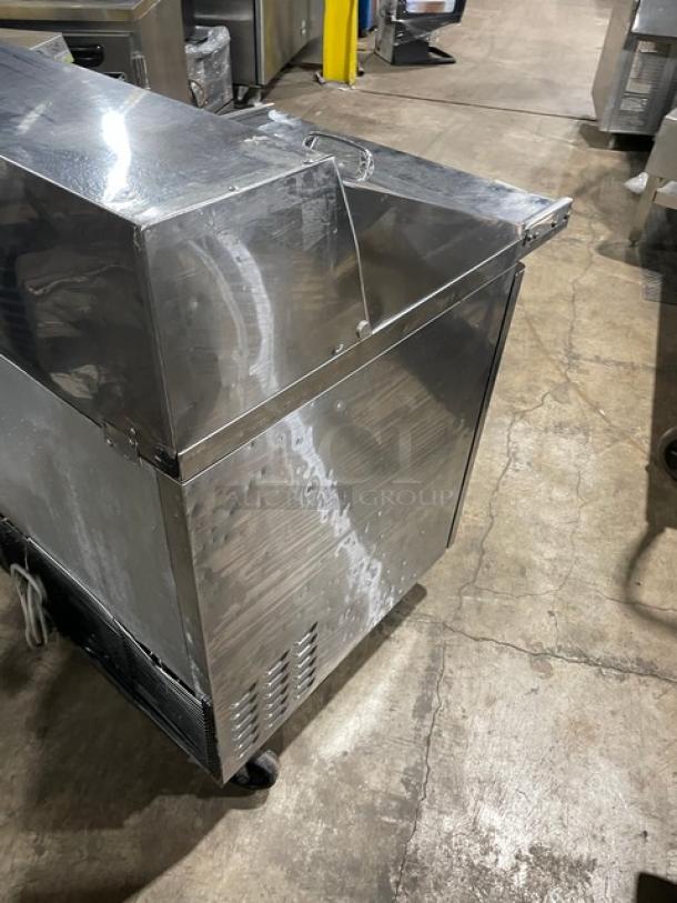 Turbo Air TST28SD12 stainless refrigerated prep table, single door, bain marie style, on casters, with wired rack.