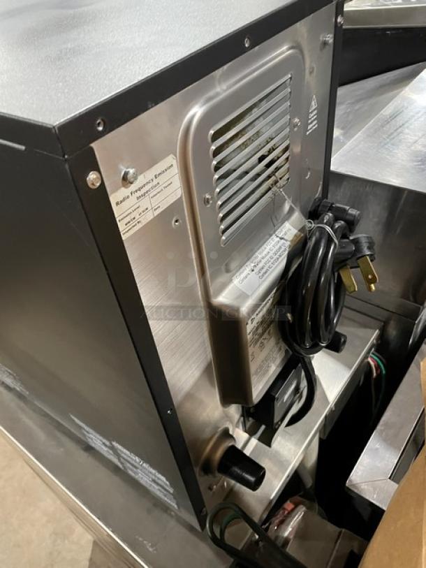 MerryChef EikonE2S high-speed cook oven, black, electric, countertop model on legs. Visible labels with model and voltage info.