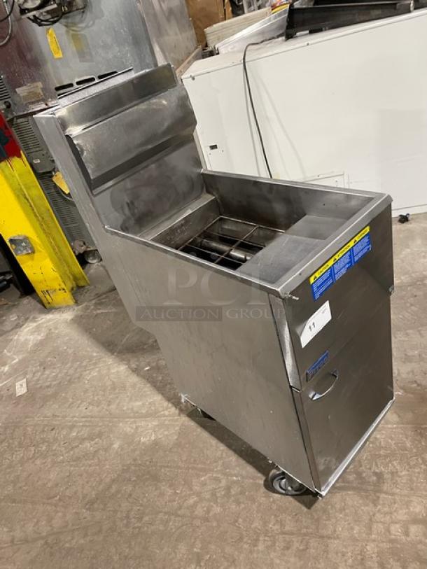 Pitco commercial stainless steel natural gas fryer with back splash, basket hanger, and casters. Slightly used condition.