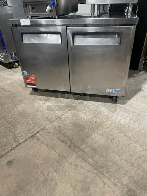 Turbo Air M3 Series stainless steel 2-door undercounter freezer, Model MUF48, on casters, Energy Star certified, with rack.