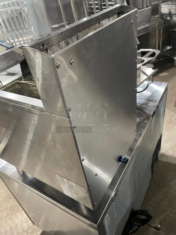 CPG stainless steel natural gas countertop fryer with backsplash, basket hanger, and fry basket. Excellent condition, on legs.