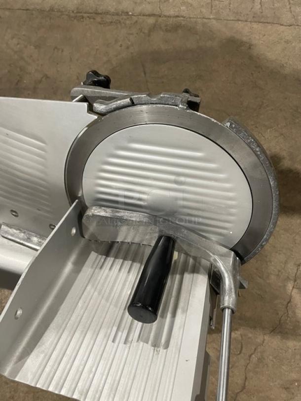 Commercial electric meat slicer, model 26MSC001, 110V, features rotary blade and sturdy construction. Semi-automatic, countertop unit.