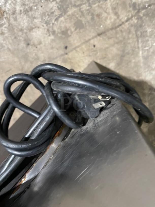 Coiled power cord of a Krampouz CECIJ40AT dual crepe maker on a stainless steel surface.