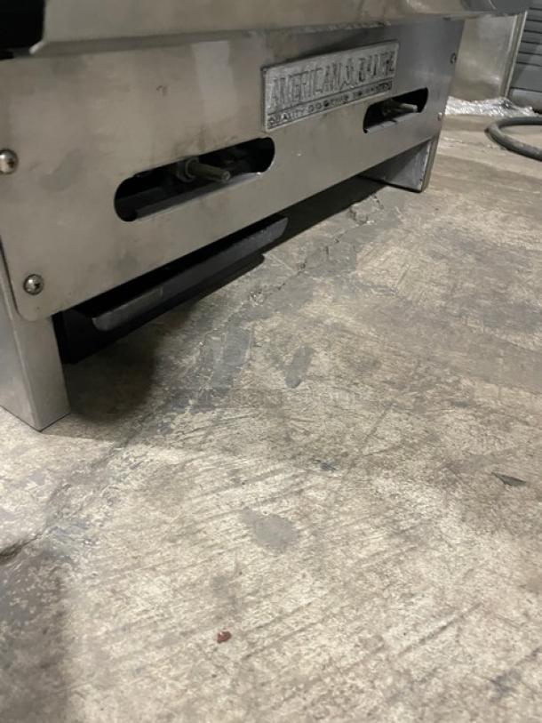 American Range stainless steel natural gas countertop flat griddle with back and side splash, sturdy construction.