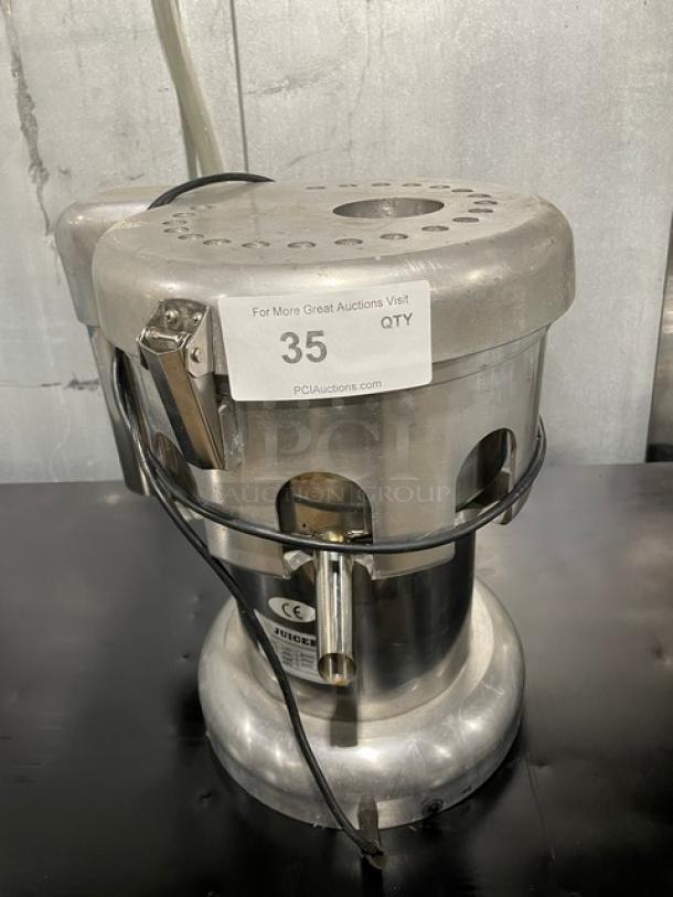 L&J WFA2000 stainless steel electric juice extractor. Countertop model, 110V, commercial use. Auction tag visible.