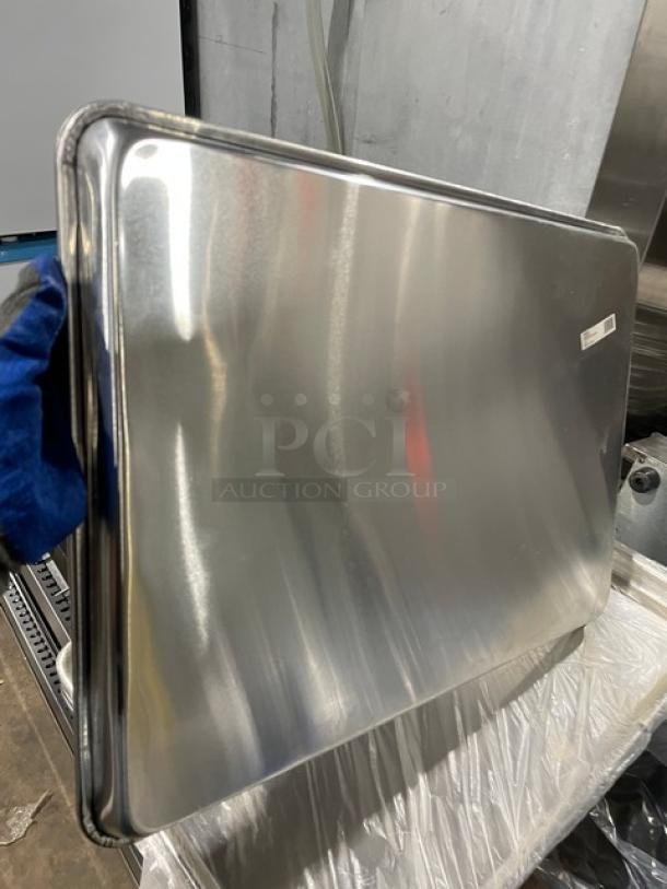 Winco Commercial Aluminum 2/3-Size Sheet Pan, Model ALXP1622, new condition, shiny surface, sticker label visible.