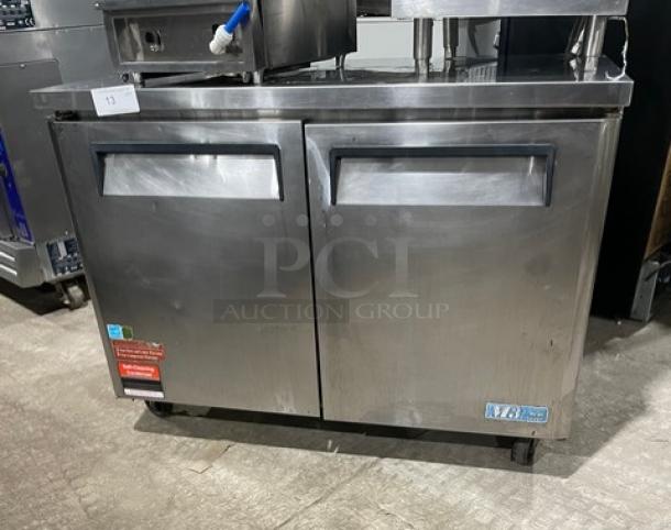 Turbo Air M3 Series stainless steel 2-door undercounter freezer, Model MUF48, on casters, Energy Star certified, with rack.