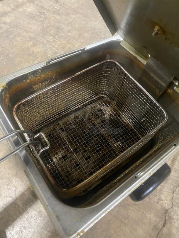 Winco EFS16 stainless steel electric countertop deep fat fryer with lid and fry basket. Shows signs of use. Model: EFS-16.