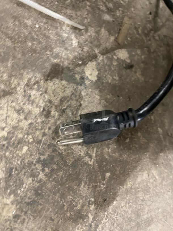Close-up of a two-prong electrical plug from a Leader LB36SC commercial refrigerated worktop.