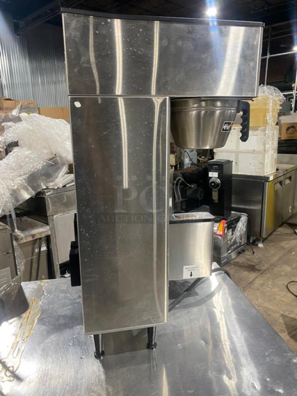 Bunn ThermoFresh stainless steel dual coffee brewer, model DUALTFDBC, with hot water dispenser, digital control, on legs.