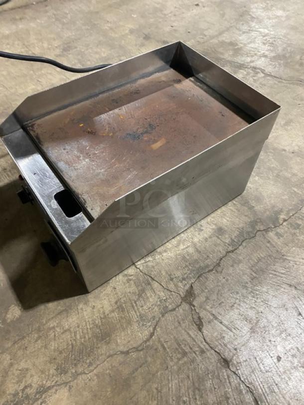 Diamond commercial stainless steel electric flat griddle with back and side splash, showing visible wear.