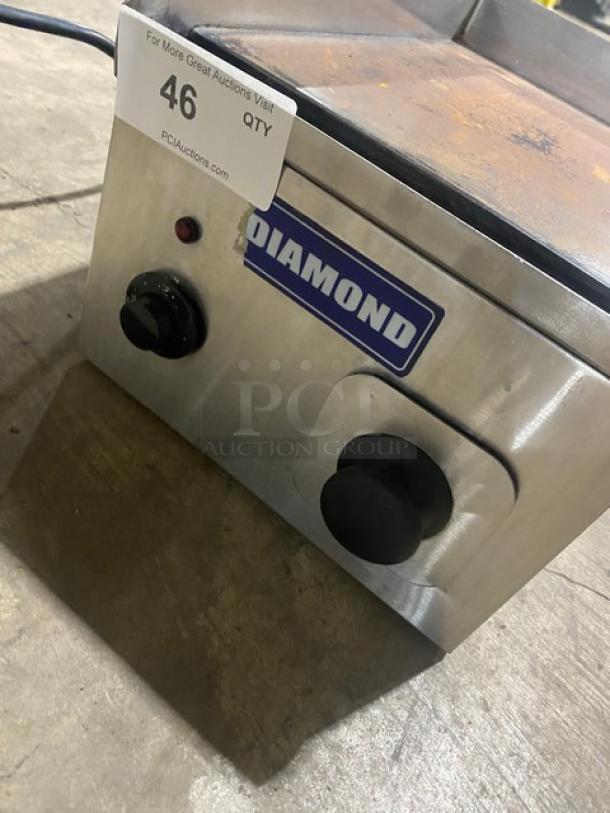 Diamond stainless steel countertop flat griddle, electric powered, with back and side splash. Features control knobs and logo.