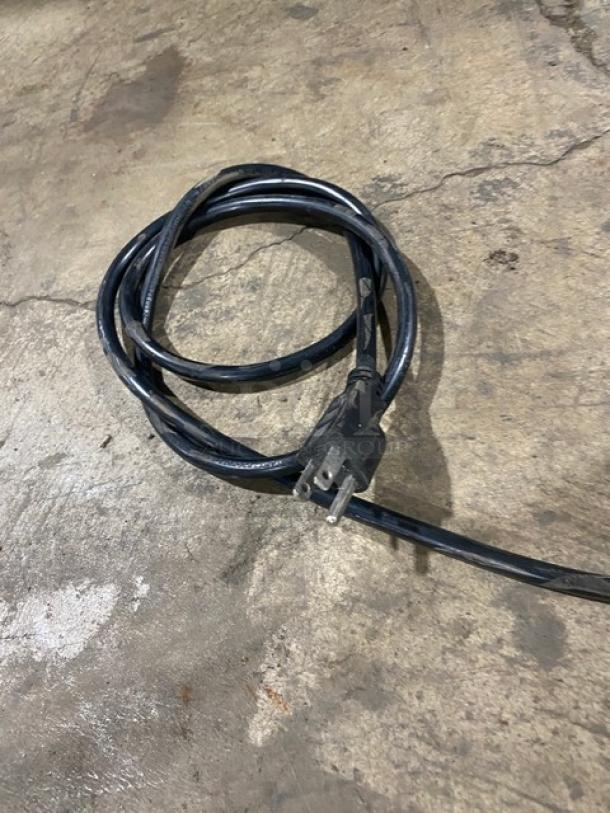 Coiled black power cable for Bunn G3HD coffee grinder, shown on a concrete surface. Plug visible.