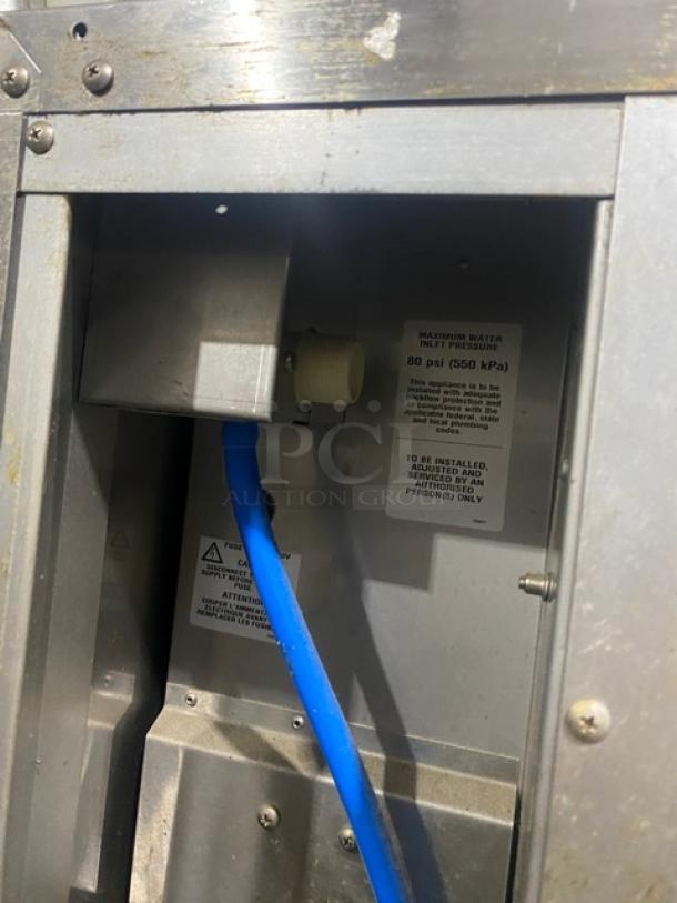 Moffat Turbofan P8M proofing cabinet interior view, showing water connection and pressure warning label.