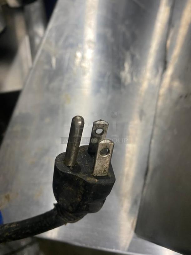 Close-up of a three-prong electrical plug for a Moffat Turbofan Series P8M heated holding/proofing cabinet.