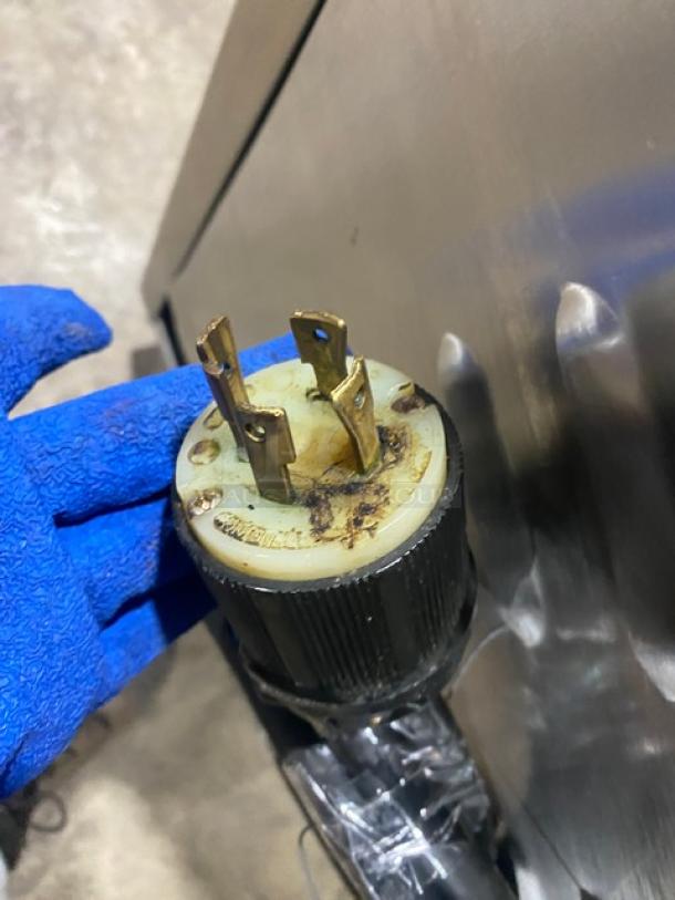 Close-up of Atwood Scale-O-Matic S300 plug with visible wear. Blue-gloved hand holding the plug.