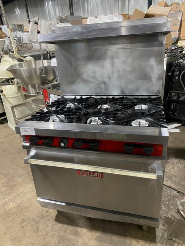 Vulcan stainless steel 6-burner range/oven combo with backsplash, overhead salamander shelf, and wired oven rack. Natural gas powered.