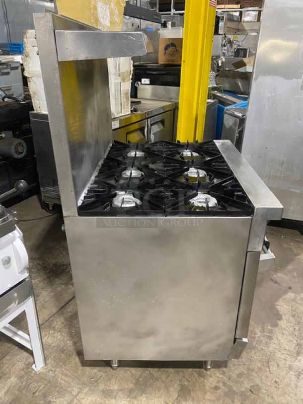 Vulcan commercial 6-burner stainless steel range with natural gas, backsplash, salamander shelf, wired oven rack, on legs.