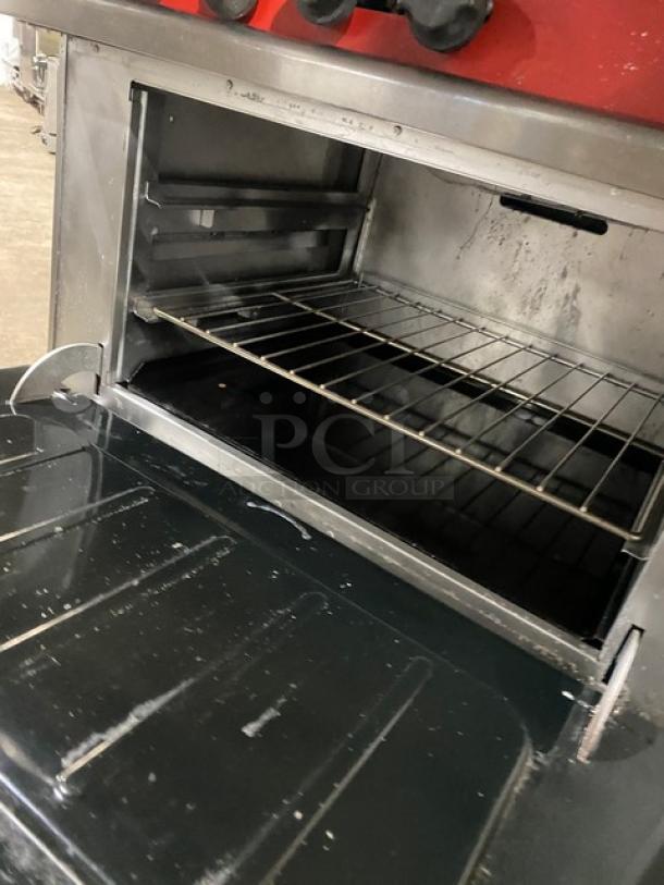 Vulcan commercial stainless steel 6-burner range/oven combo with backsplash, overhead salamander shelf, and wired oven rack.