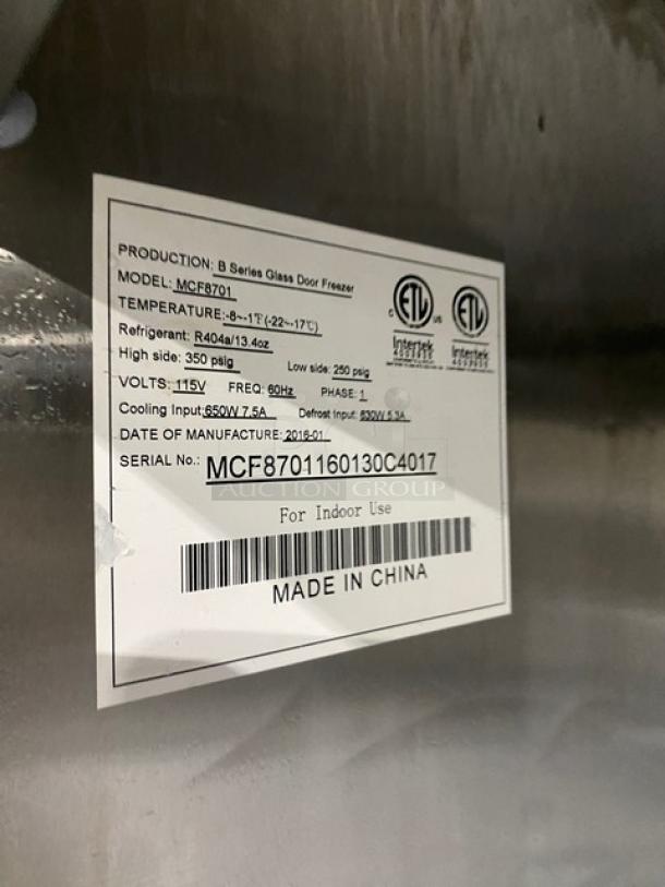 Atosa MCF8701 stainless steel glass door bottom-mount freezer. Model MCF8701, SN: MCF8701160130C4017, 115V, on casters.