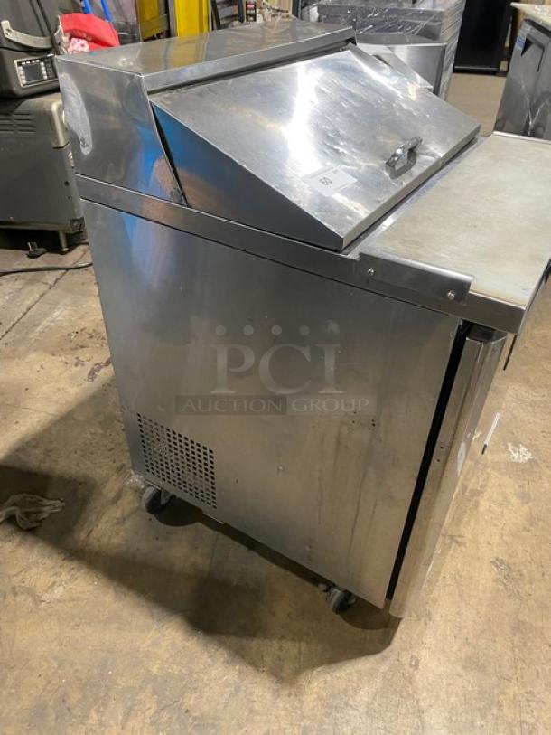 Turbo Air MST-28 refrigerated prep table, stainless steel, bain marie style, single door, with cutting board, on casters.