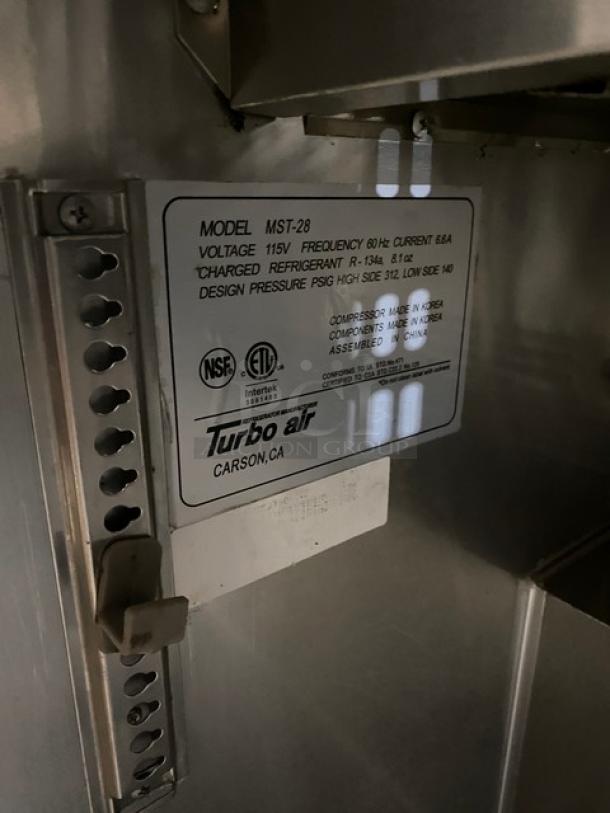 Turbo Air MST-28 model label, 115V, details NSF and ETL certifications, charged refrigerant R-134a, made in USA.