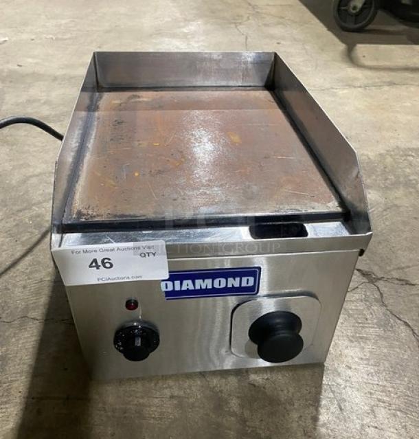 Diamond commercial electric stainless steel countertop flat griddle with back and side splash, visible controls, used condition.