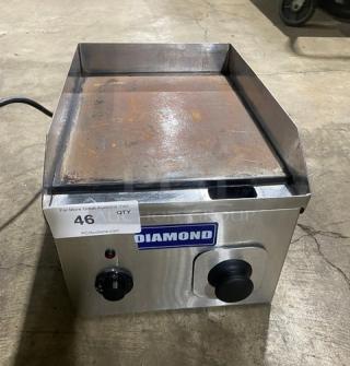 Diamond commercial electric stainless steel countertop flat griddle with back and side splash, visible controls, used condition.