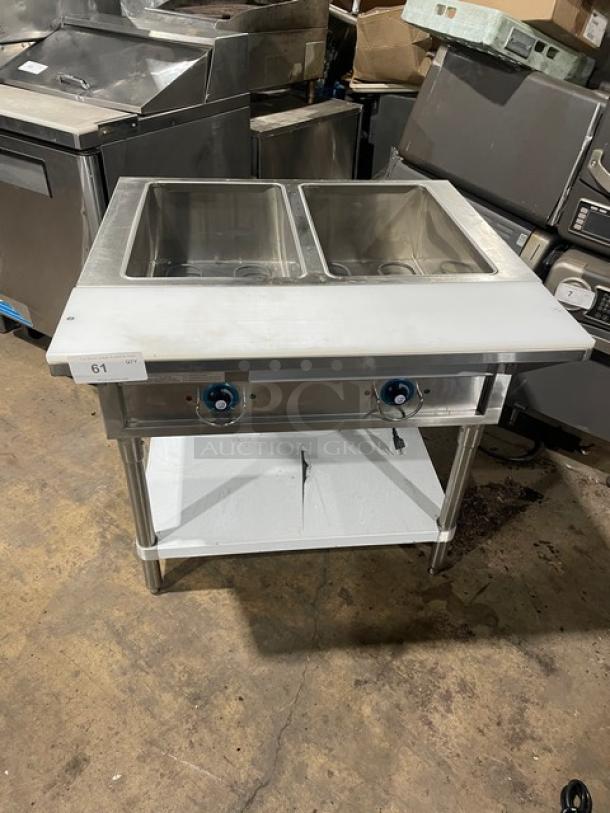 Prepline stainless steel electric 2-well steam table with cutting board and undershelf, model EST302O, 120V, on legs.