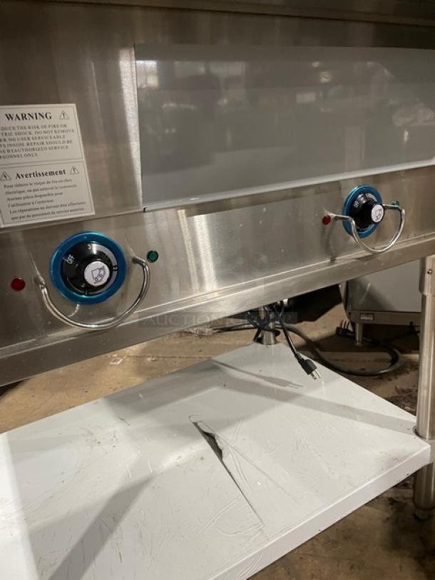 Prepline EST302O commercial stainless steel 2-well hot food table with cutting board and undershelf, 120V, on legs.