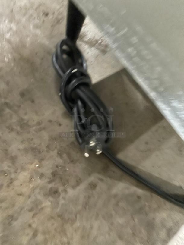 Coiled power cord of Hoshizaki DCM-270BAH-OS ice maker, showing part of the stainless steel exterior and support legs.