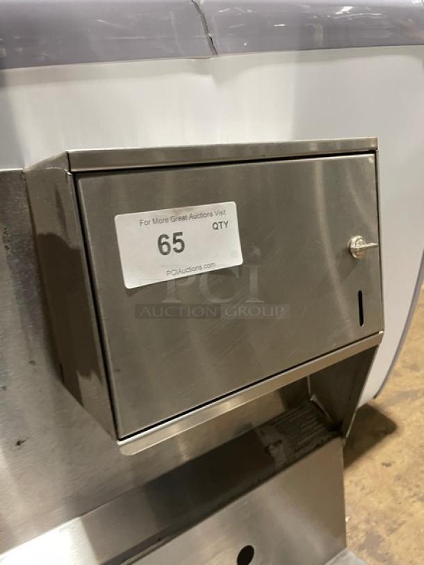 Advance Tabco stainless steel wall-mount hand sink, single well, with backsplash, built-in paper towel dispenser, item tag "65".