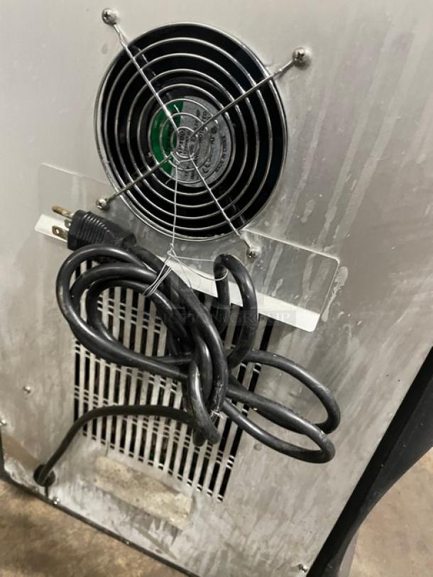 Bolla Commercial Dual-Flavor Iced Coffee Dispenser with stainless steel hopper, electric powered, countertop model. Visible power cord and fan at the back.