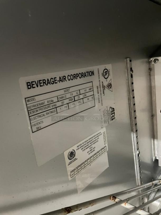 Beverage-Air UCR27 commercial refrigerator, stainless steel, single door, undercounter model on casters. Features poly coated wired rack, 115V, 1 phase. Label details model and electrical specifications.