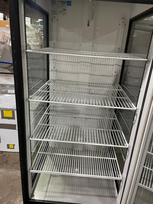 True GEM-23 commercial glass door merchandiser refrigerator, black, Energy Star certified, poly coated wired racks, SN: 7259029.