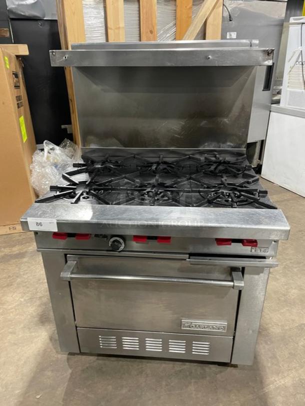 Garland stainless steel 6-burner range/oven combo with backsplash, overhead salamander shelf, wired oven rack; on casters.