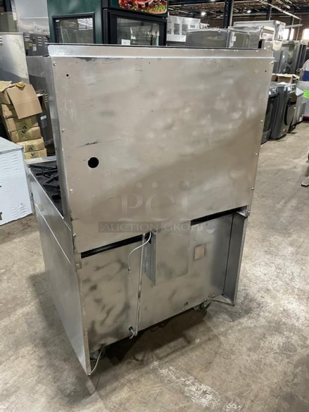 Garland stainless steel 6-burner range/oven combo with backsplash, overhead salamander shelf, wired oven rack, on casters.