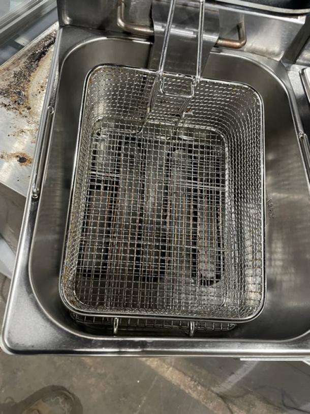 Adcraft DF6L2 stainless steel dual-tank fryer, includes mesh fry basket and knobbed lid. Serial number: 21010090003.