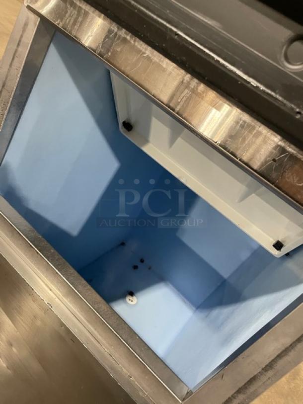 Hoshizaki KM-515MAH ice maker bin interior, clean condition, stainless steel, Energy Star certified, on legs.