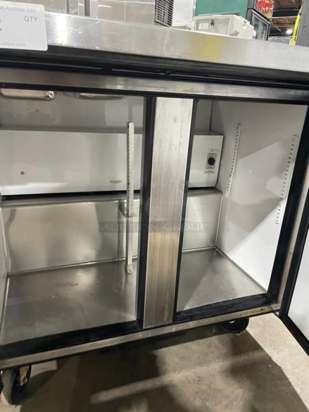 True commercial stainless steel 2-door refrigerated salad prep table, model TSSU-36-12M-B, on casters, in good condition.