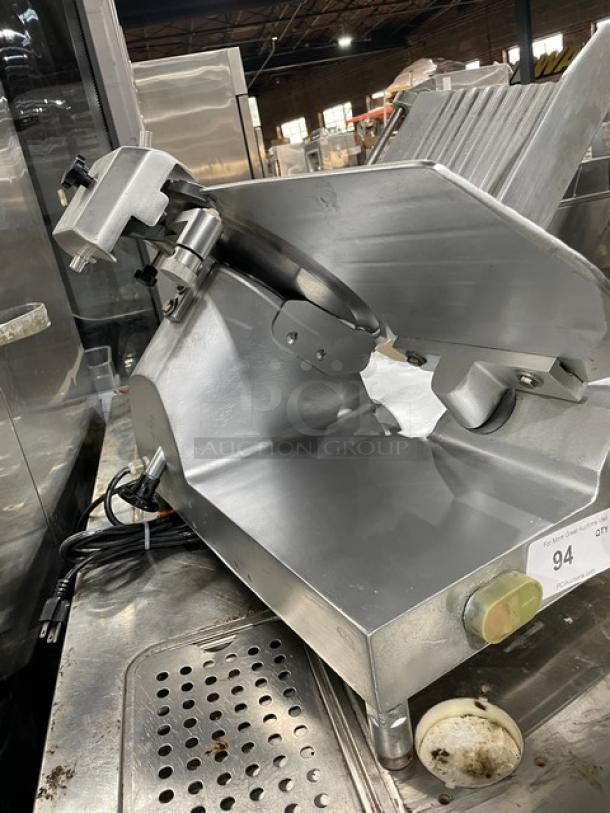 Avantco commercial electric deli meat slicer, heavy-duty countertop design on legs, stainless steel, used condition, model details not visible.
