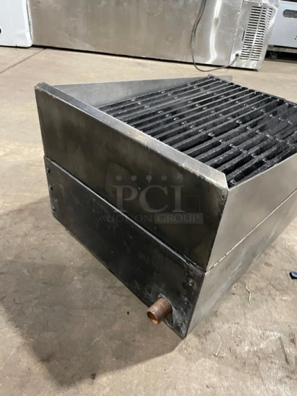 Commercial stainless steel countertop char broiler with cast iron grate, natural gas powered, robust design, pre-owned condition.