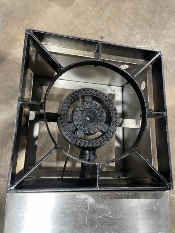 Commercial stainless steel natural gas stock pot range with single burner, sturdy legs, durable condition, ideal for kitchens.